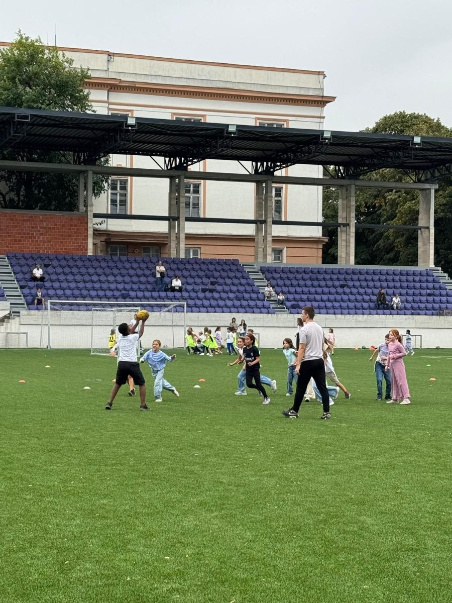 Students and teachers on the pitch during French National Sports Day